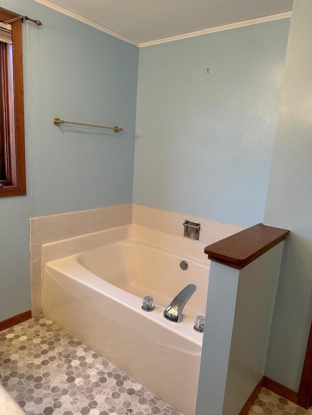 bathroom with ornamental molding and a bathing tub