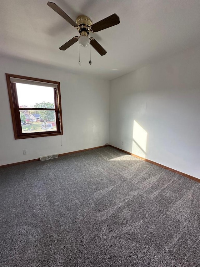 spare room featuring ceiling fan and carpet flooring