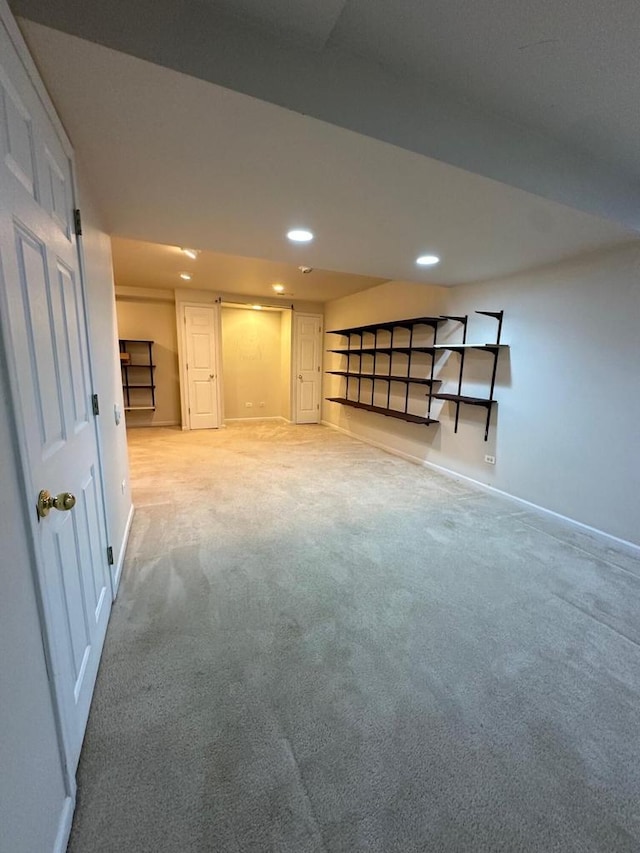 basement featuring light colored carpet