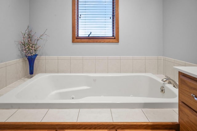 bathroom featuring vanity and tiled tub