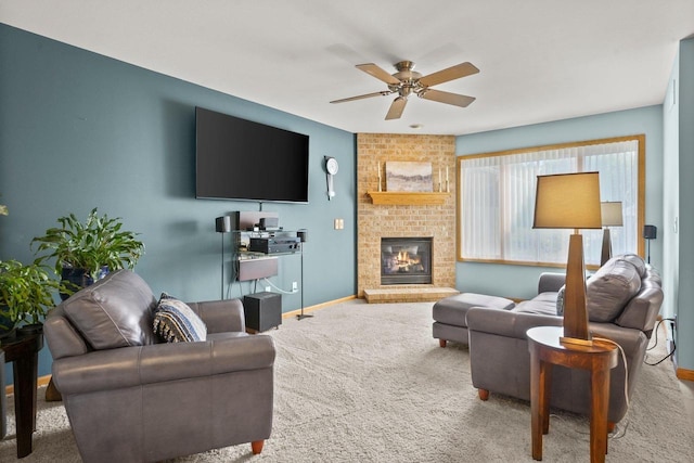 living room featuring a brick fireplace, carpet flooring, and ceiling fan