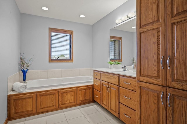 bathroom with vanity, tile patterned flooring, and a washtub