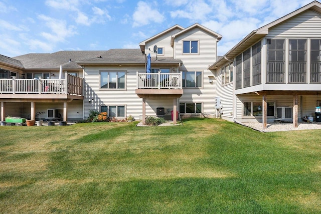 rear view of property featuring central AC, a yard, and a sunroom