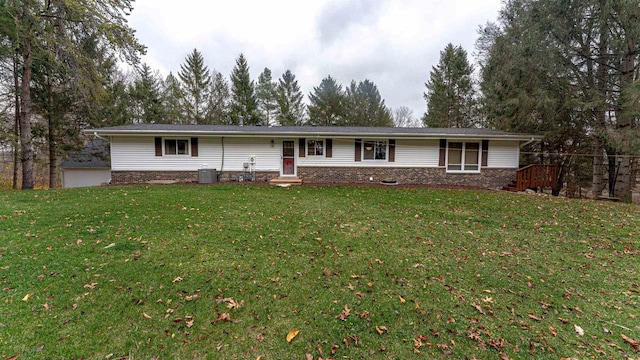 ranch-style home featuring a front yard and central air condition unit