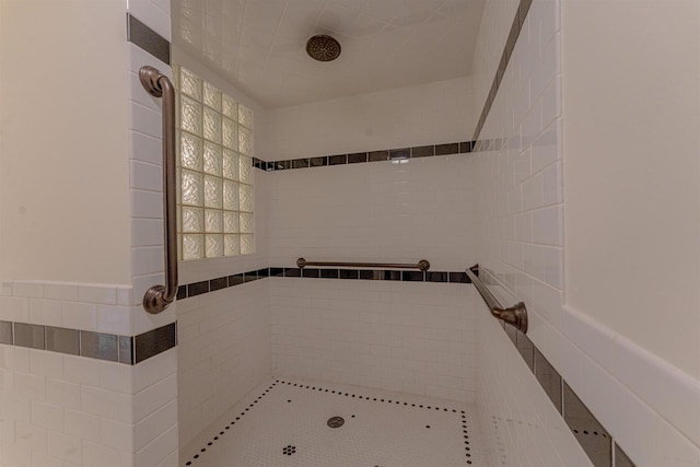 bathroom with a tile shower