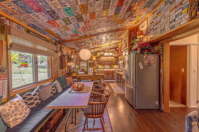 dining area with hardwood / wood-style flooring, wood walls, and lofted ceiling