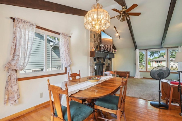 dining room with light hardwood / wood-style flooring, vaulted ceiling with beams, and ceiling fan with notable chandelier