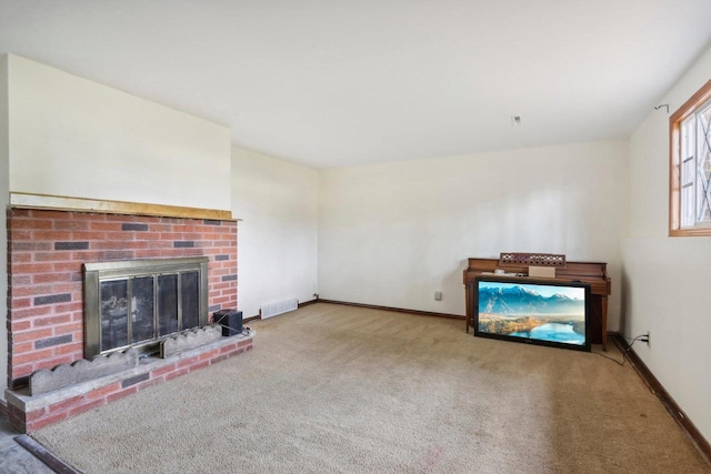 unfurnished living room featuring a fireplace and carpet flooring