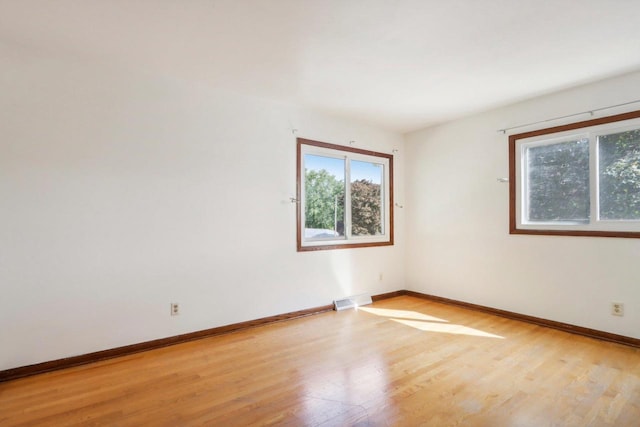 unfurnished room with light hardwood / wood-style flooring