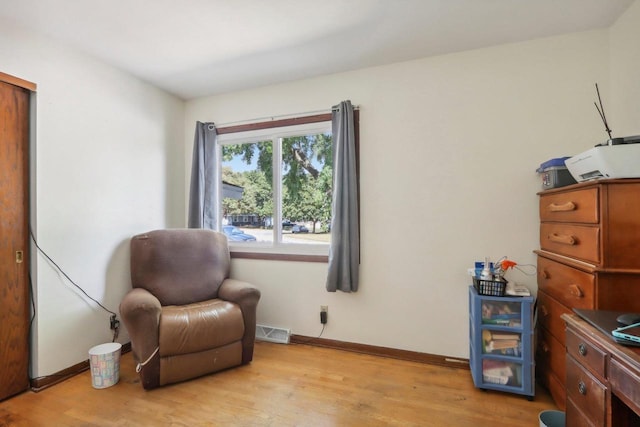 sitting room with light hardwood / wood-style flooring