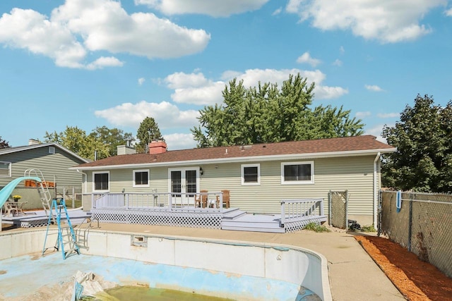 back of property featuring a swimming pool side deck