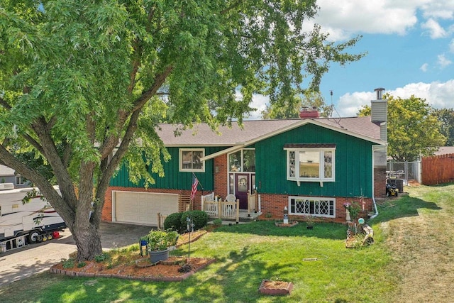 view of front of home with central AC unit, a front yard, and a garage