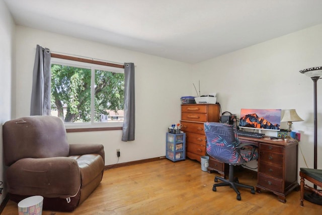 home office with light hardwood / wood-style floors