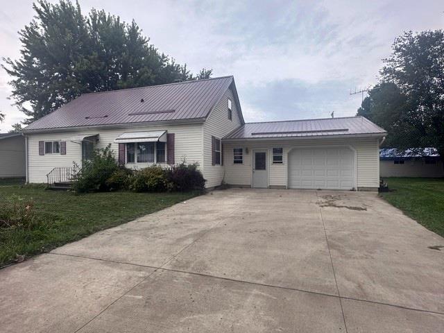 view of front of property with a garage and a front yard