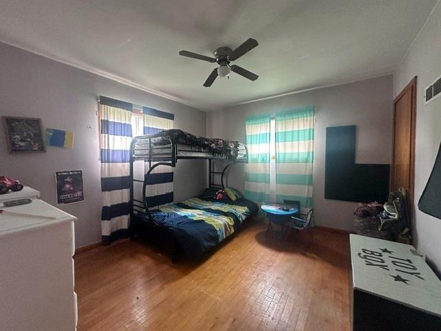 bedroom featuring hardwood / wood-style floors and ceiling fan