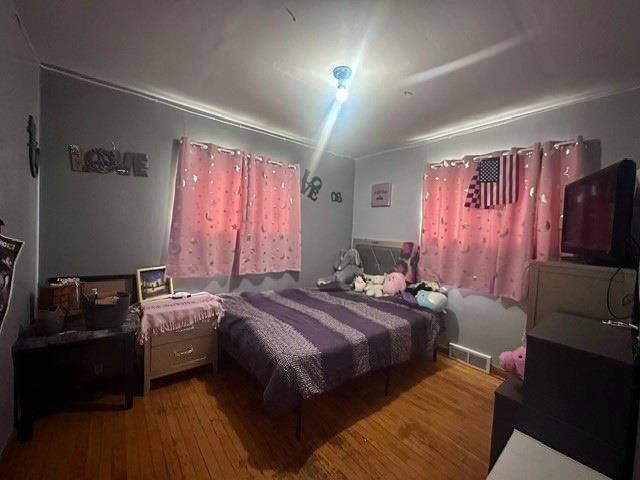 bedroom with hardwood / wood-style floors