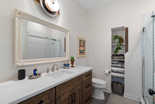 bathroom with tile patterned flooring, a shower with door, vanity, and toilet