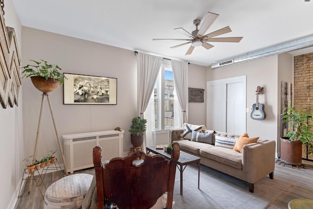 living room featuring radiator, ceiling fan, and hardwood / wood-style floors