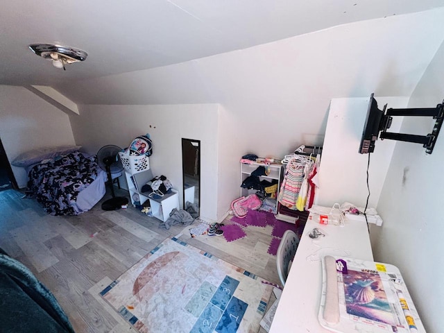 additional living space featuring hardwood / wood-style flooring and lofted ceiling