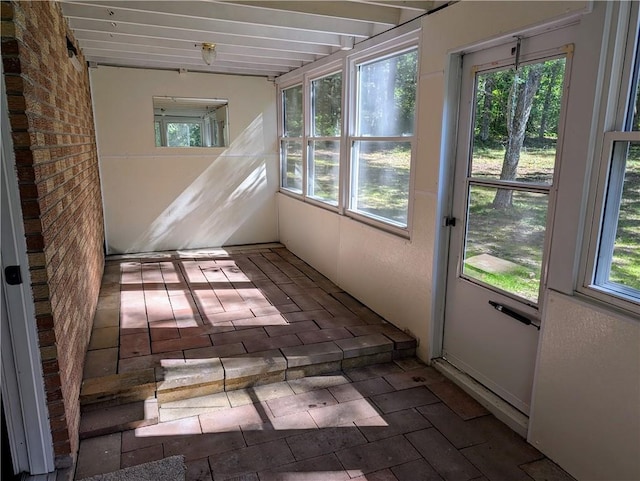 unfurnished sunroom featuring plenty of natural light