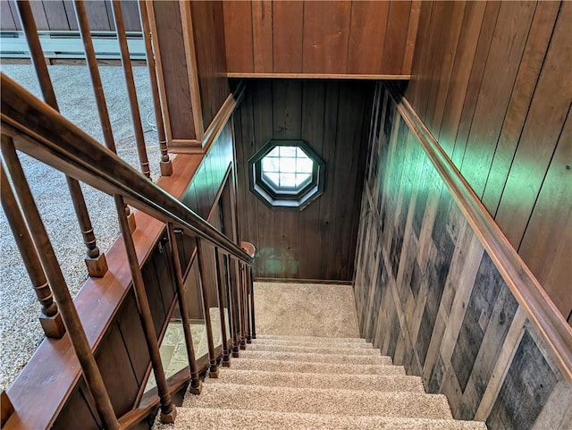 stairs with wooden walls and carpet