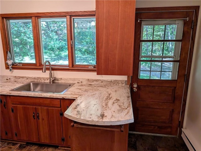 kitchen with a baseboard heating unit and sink