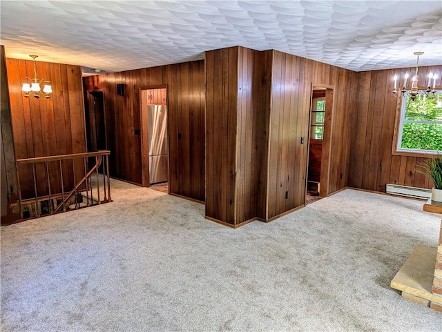 interior space featuring a baseboard radiator, wood walls, and a chandelier