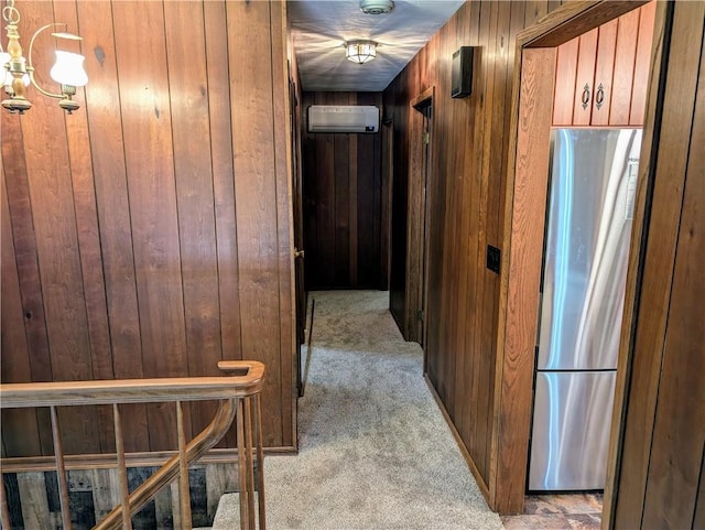 hall with light colored carpet, wood walls, and a wall unit AC