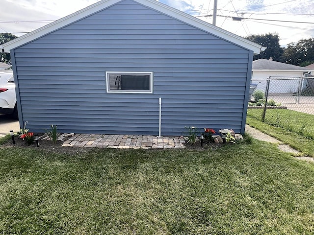 view of side of home with a lawn