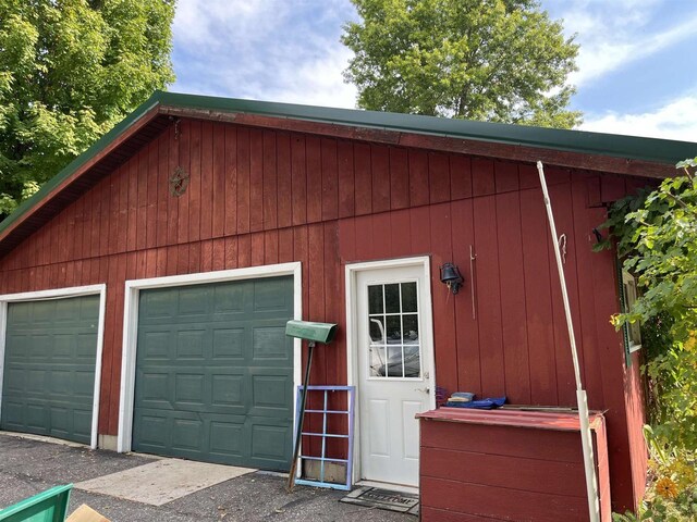 garage featuring wooden walls