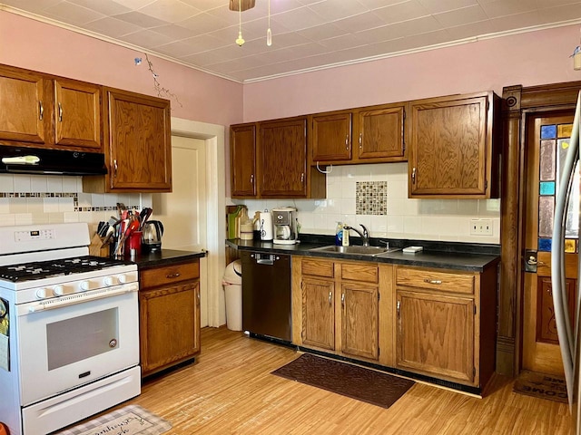 kitchen featuring black dishwasher, light hardwood / wood-style floors, gas range gas stove, sink, and backsplash