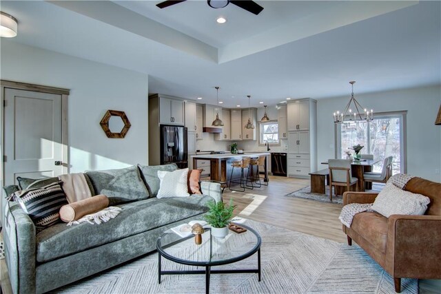 kitchen with appliances with stainless steel finishes, a kitchen island, decorative light fixtures, white cabinetry, and blue cabinets