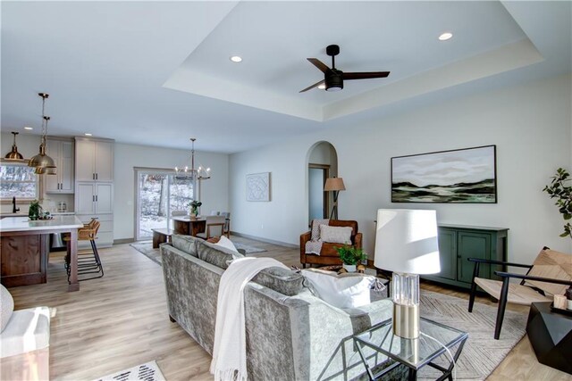 kitchen with a center island, white cabinetry, stainless steel appliances, blue cabinetry, and premium range hood