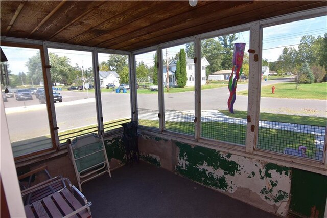 sunroom with wood ceiling and a healthy amount of sunlight