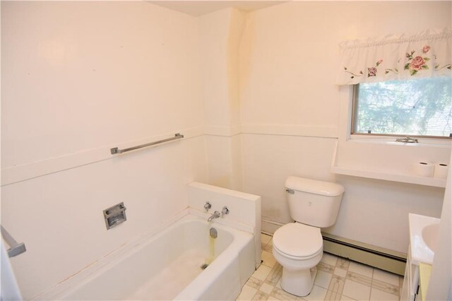 bathroom featuring toilet, a washtub, and a baseboard heating unit