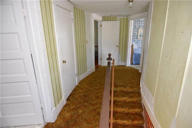 corridor featuring dark carpet