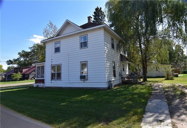 view of side of home featuring a lawn