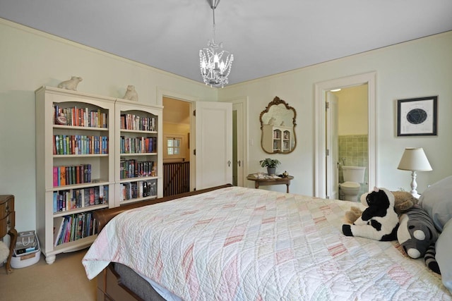 bedroom with carpet floors, a chandelier, and ensuite bathroom