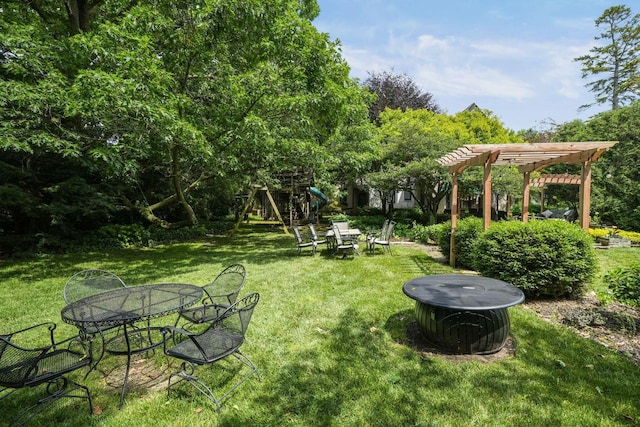 view of yard with a pergola and a playground