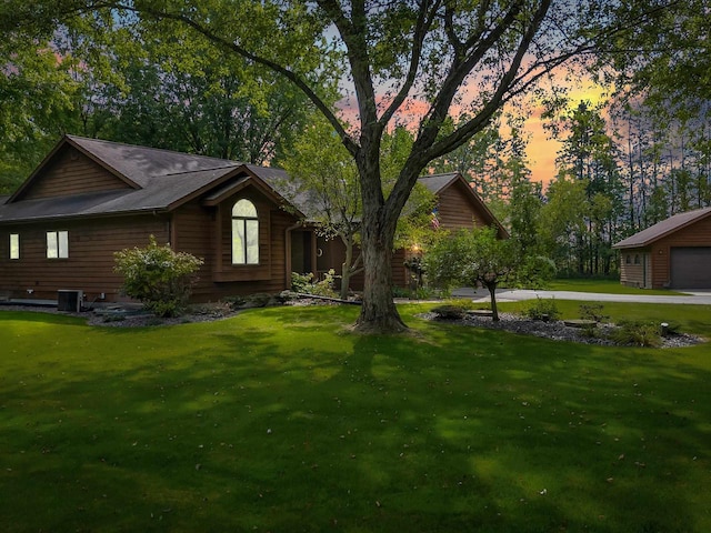 exterior space with a lawn, an outbuilding, and cooling unit