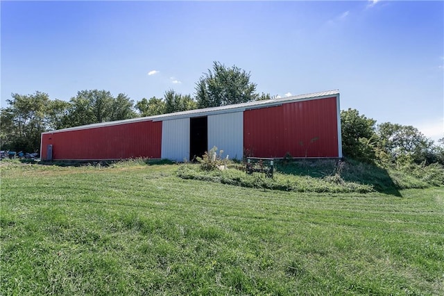 view of outdoor structure featuring a lawn