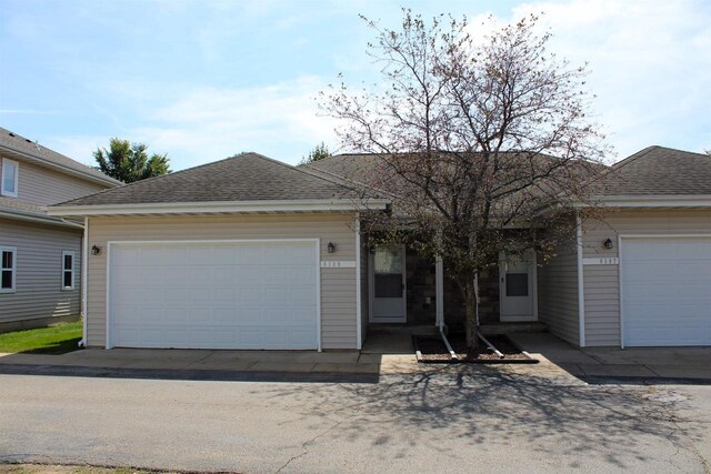 ranch-style home featuring a garage