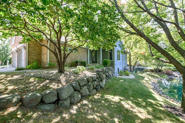 exterior space with a garage and a front lawn