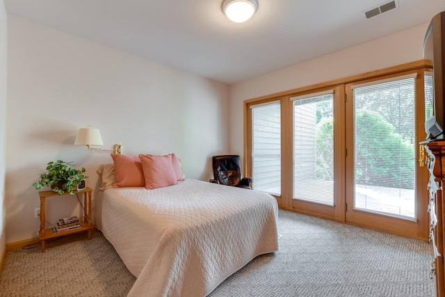 bedroom featuring access to outside and light colored carpet