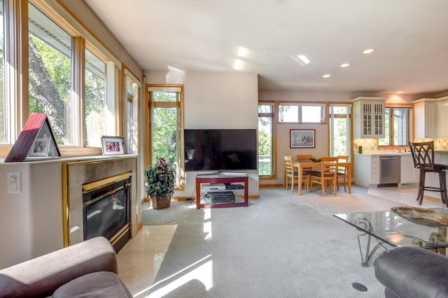 carpeted living room with plenty of natural light and a fireplace