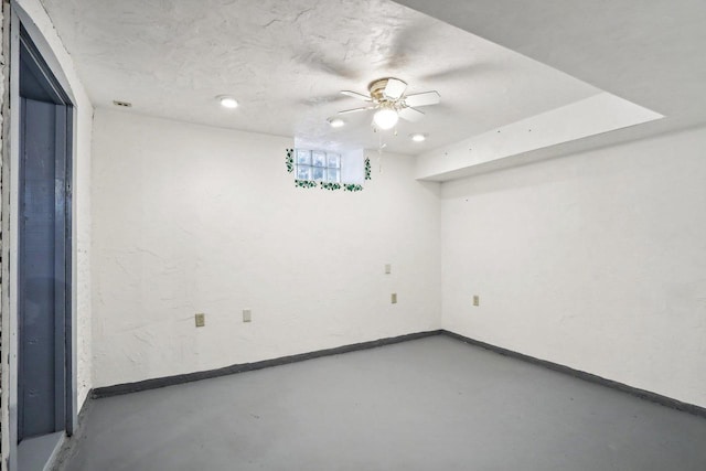 empty room with concrete floors and ceiling fan