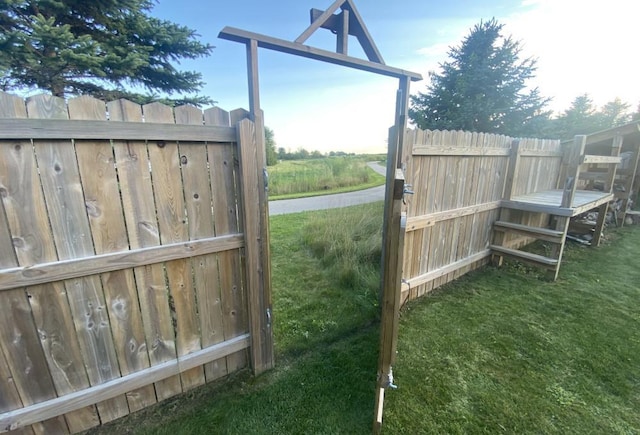 view of gate featuring a lawn