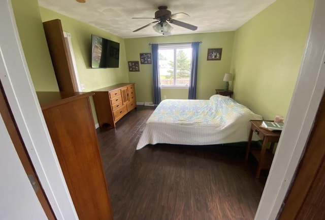 bedroom featuring a closet, ceiling fan, and dark hardwood / wood-style floors