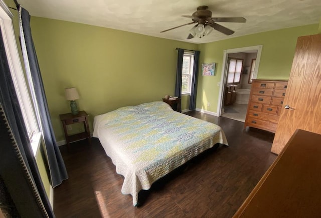 bedroom featuring connected bathroom, ceiling fan, and dark hardwood / wood-style flooring