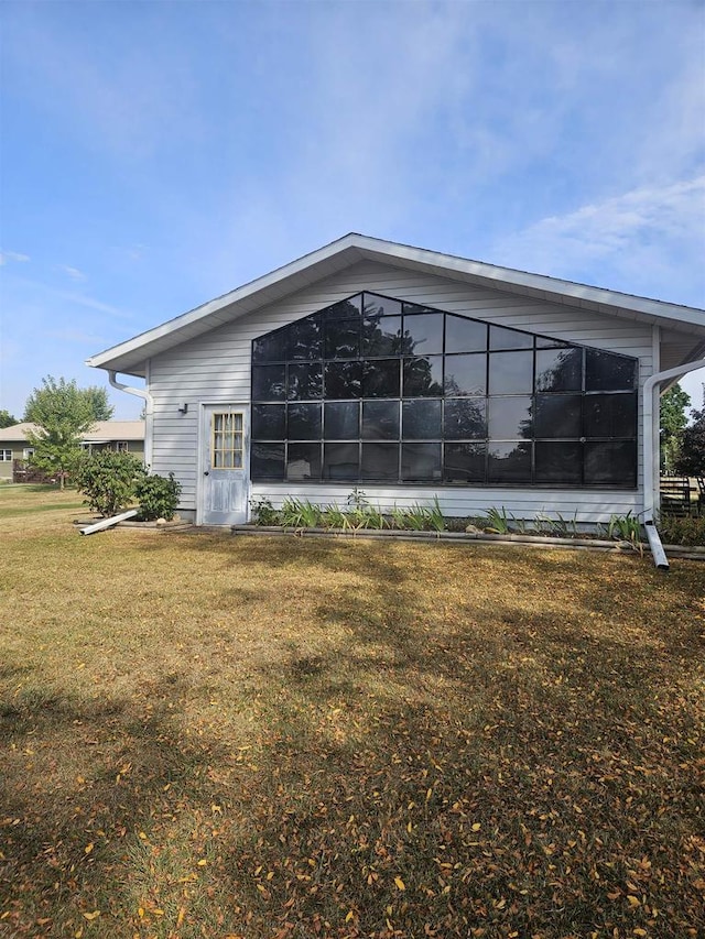 rear view of house with a yard